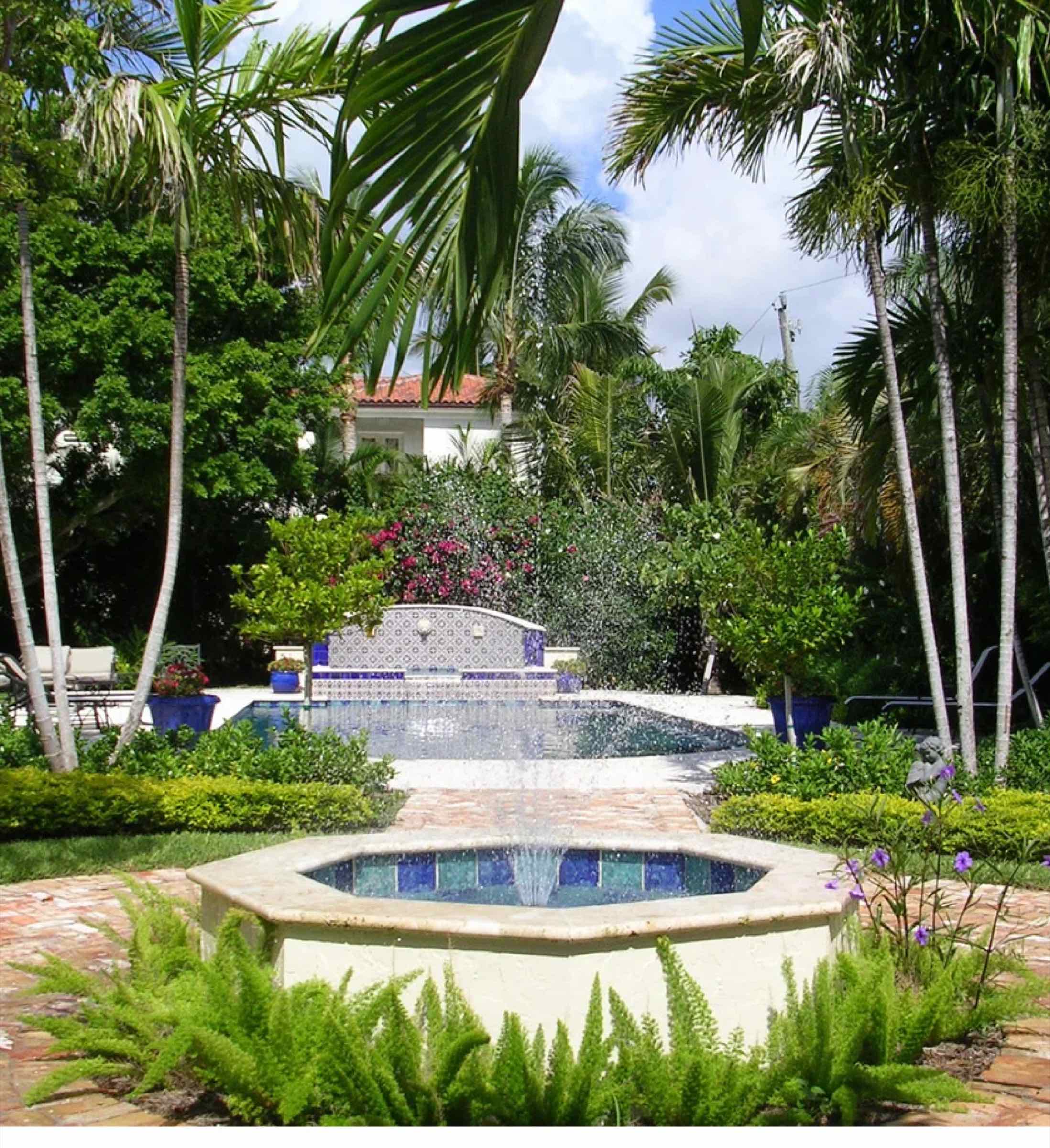 Residential pool garden with layered tropical plantings in Delray Beach