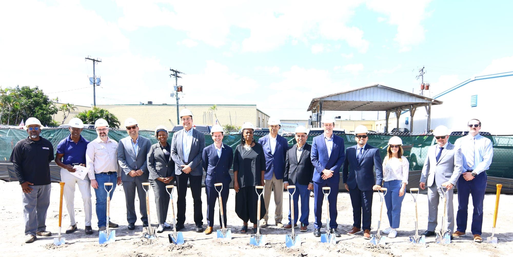 Officials and project partners lined up with ceremonial shovels at the Legacy at 45th Street groundbreaking